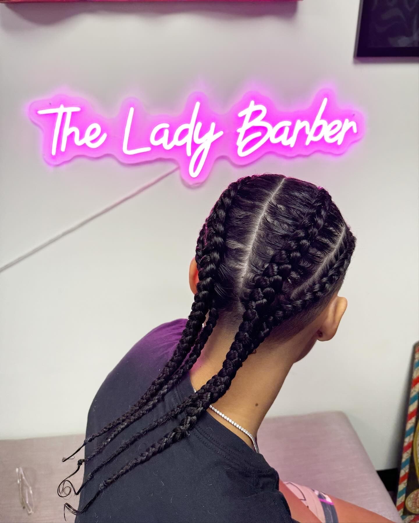 Four braids under The Lady Barber sign