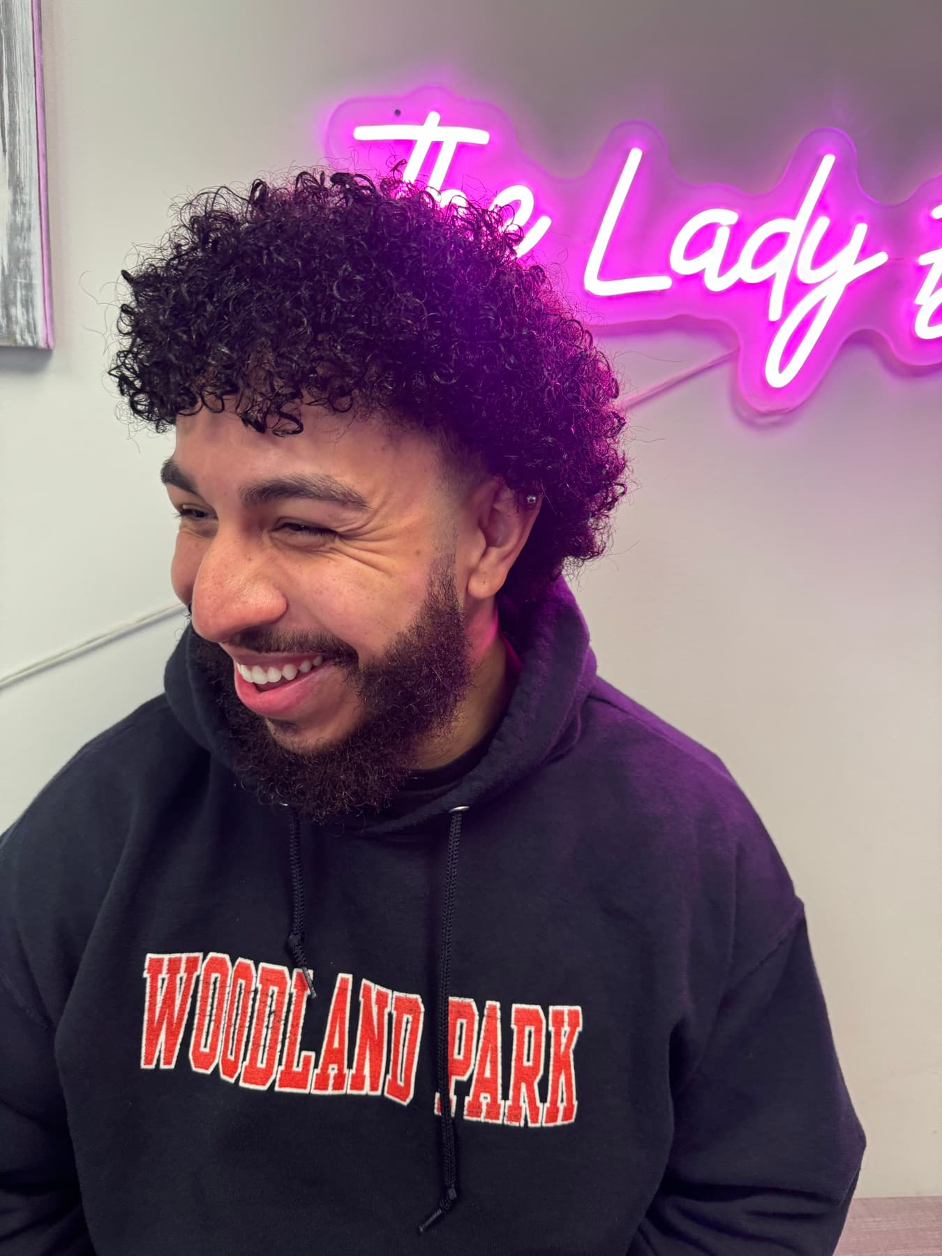 Client laughing with fresh curls and a shaped beard