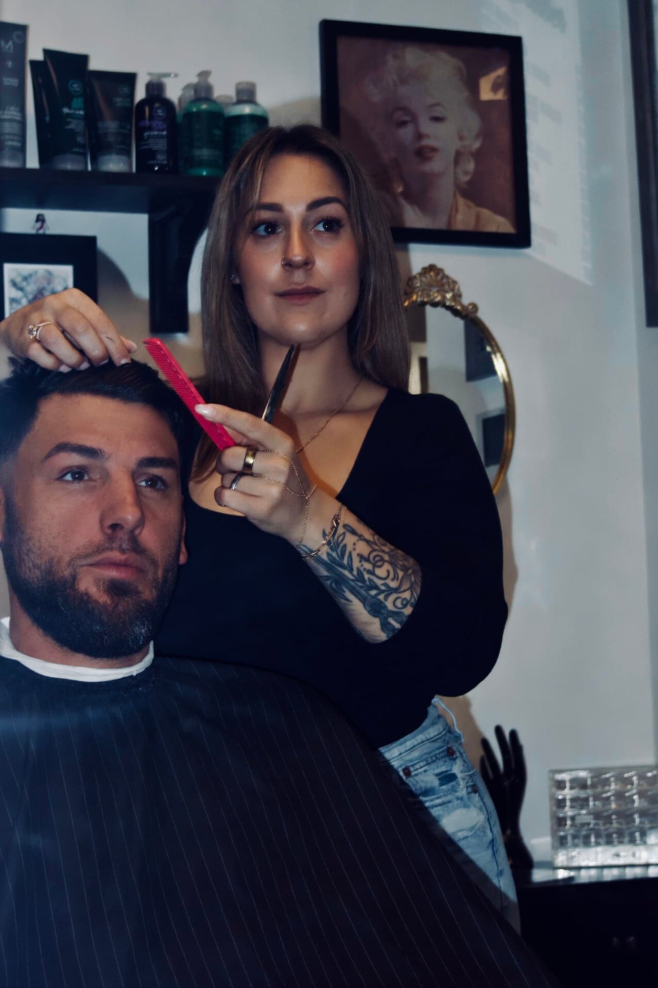 Jenna combing and cutting a client's hair