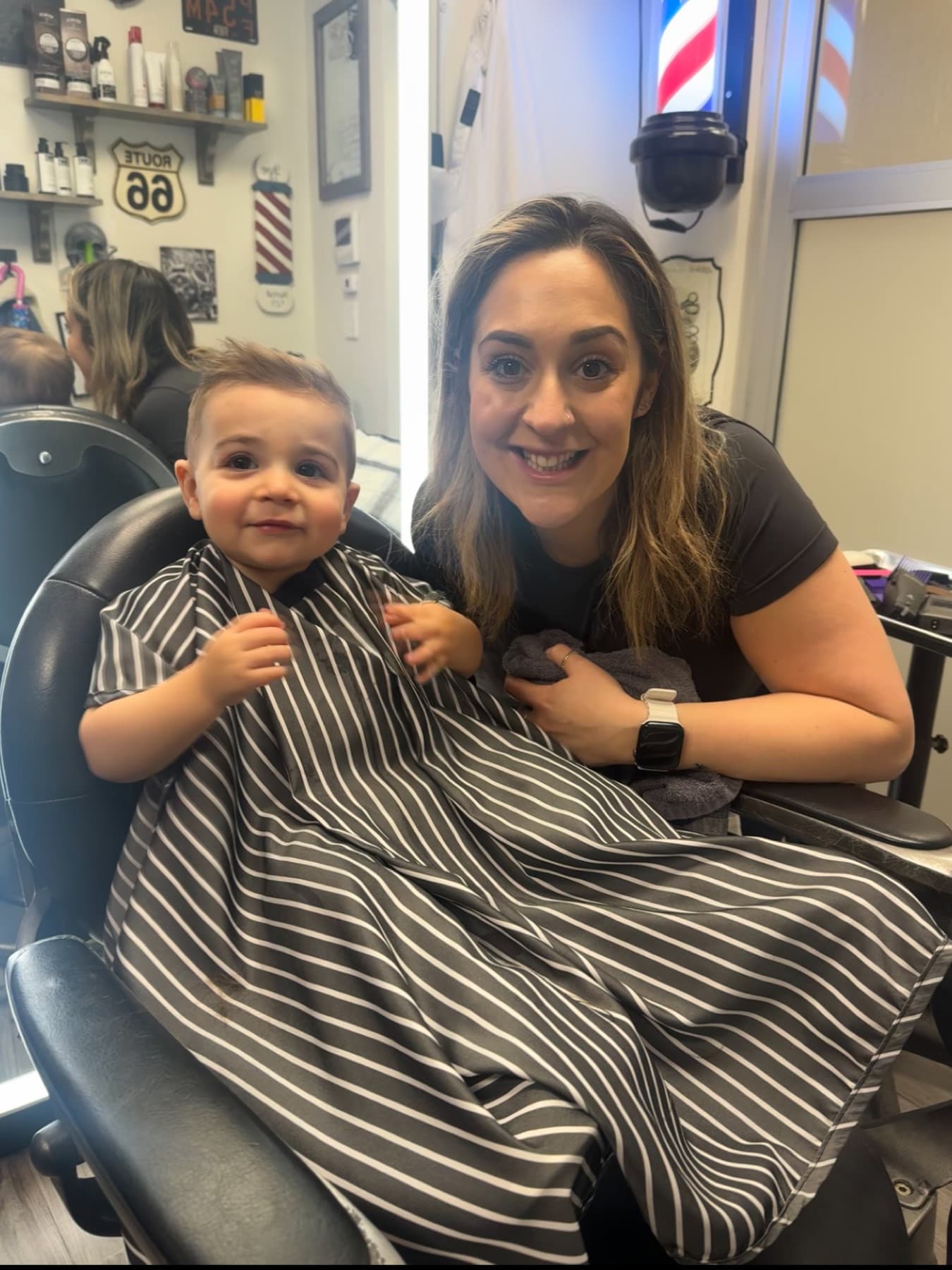 Jenna with a toddler in the barber chair