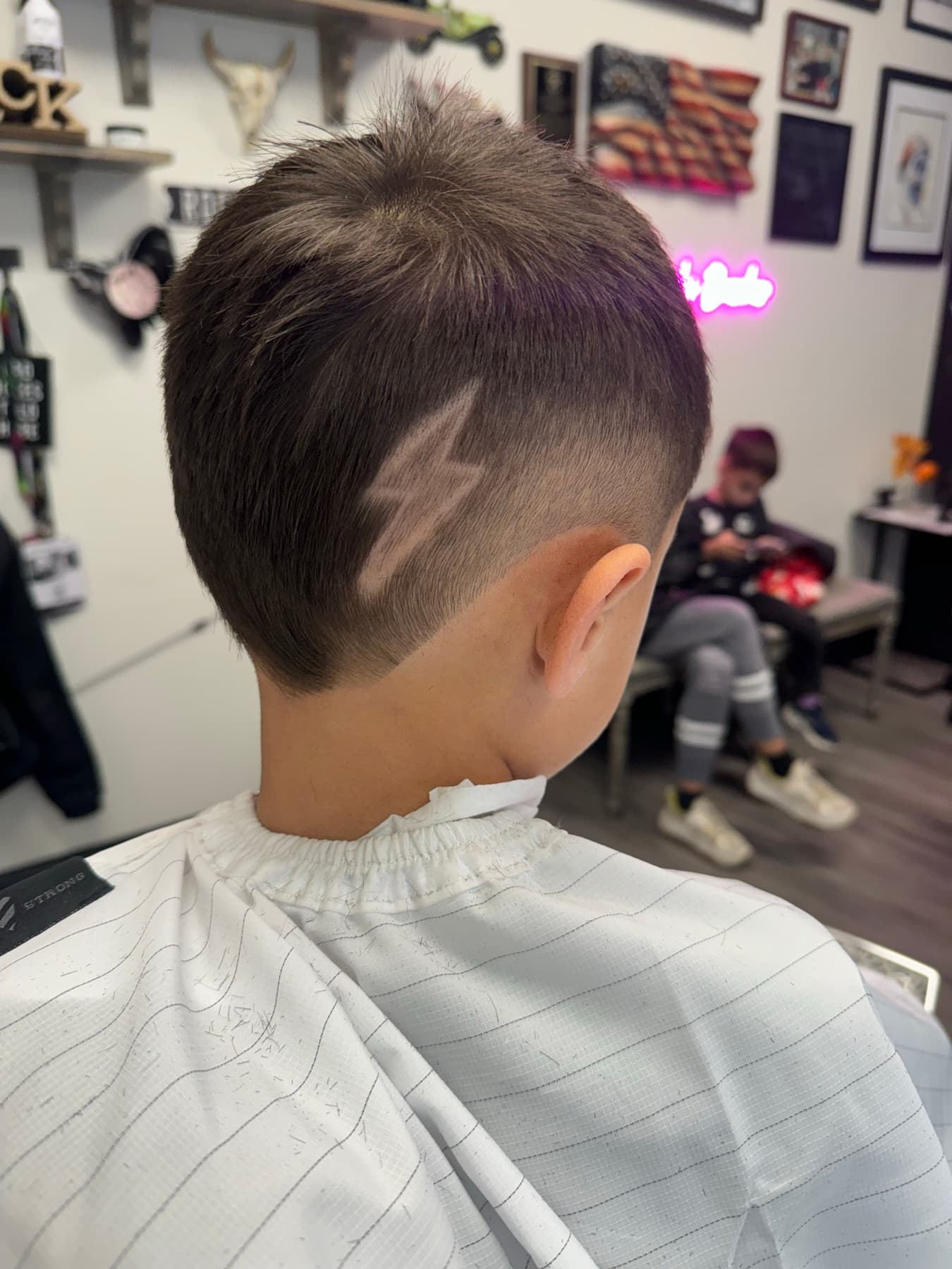 Kid's cut with a lightning bolt design