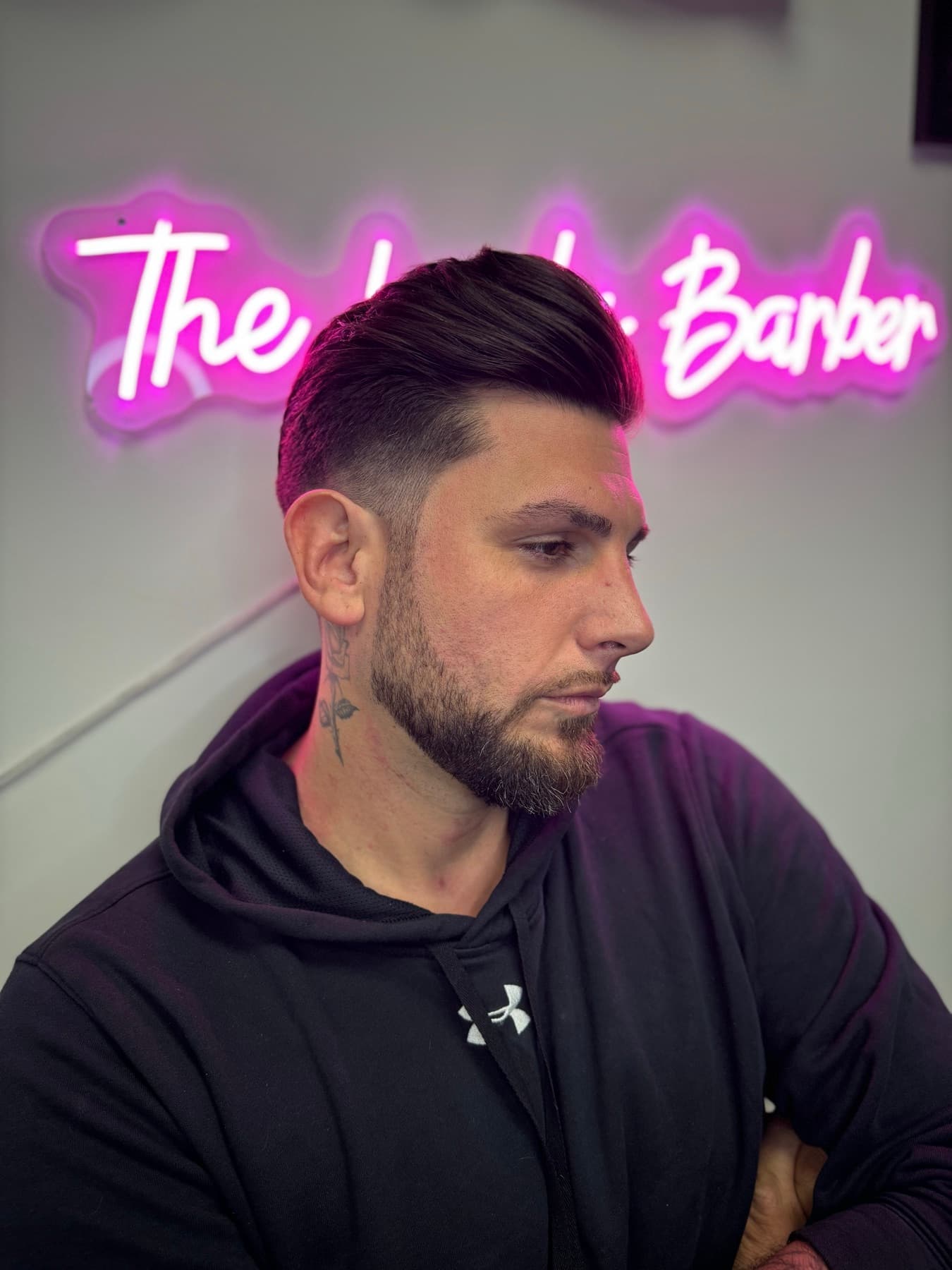 Client with a slick-back fade under The Lady Barber sign