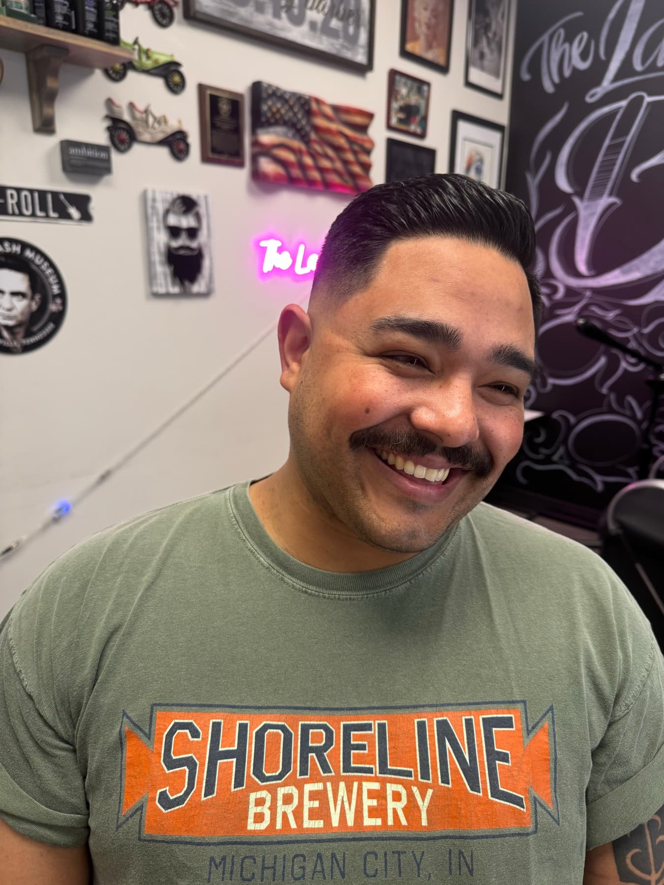 Smiling client with a fresh slick-back fade at The Lady Barber